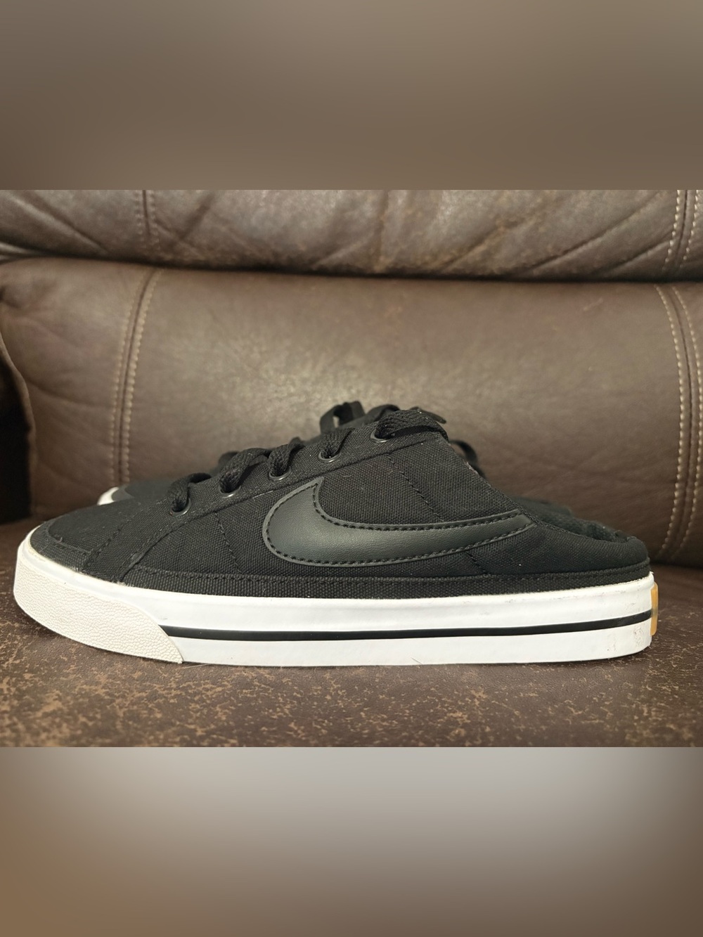 Nike women’s size 6  Black Canvas Low-Top Sneaker with White Midsole slip on